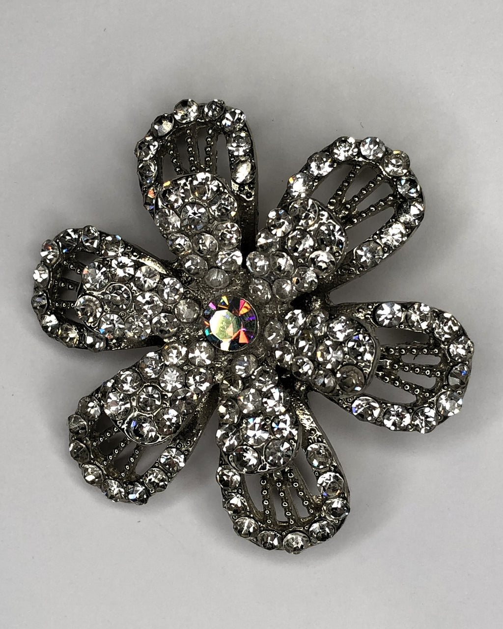 Large open double petal silver flower with rainbow diamante centre brooch at erika