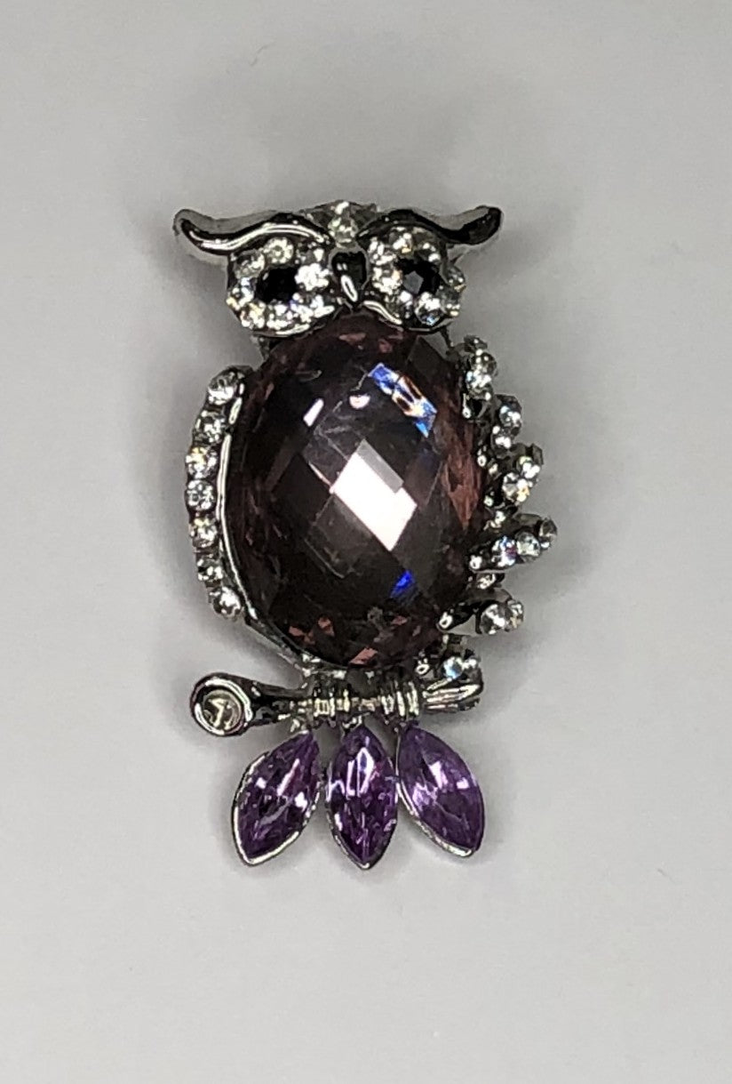 Silver owl with faceted body and purple tail feathers brooch at erika
