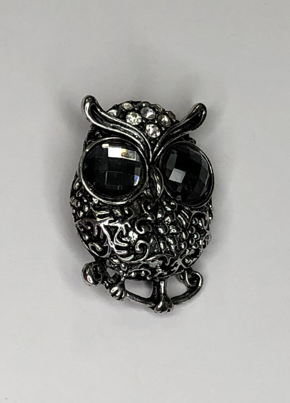 Silver owl with large grey faceted eyes brooch at erika