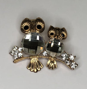 Two gold  and clear stone owls perched on branch brooch at erika