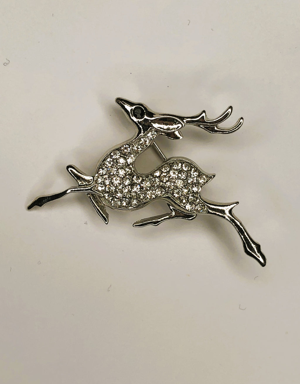 Silver galloping reindeer with diamante body brooch at erika
