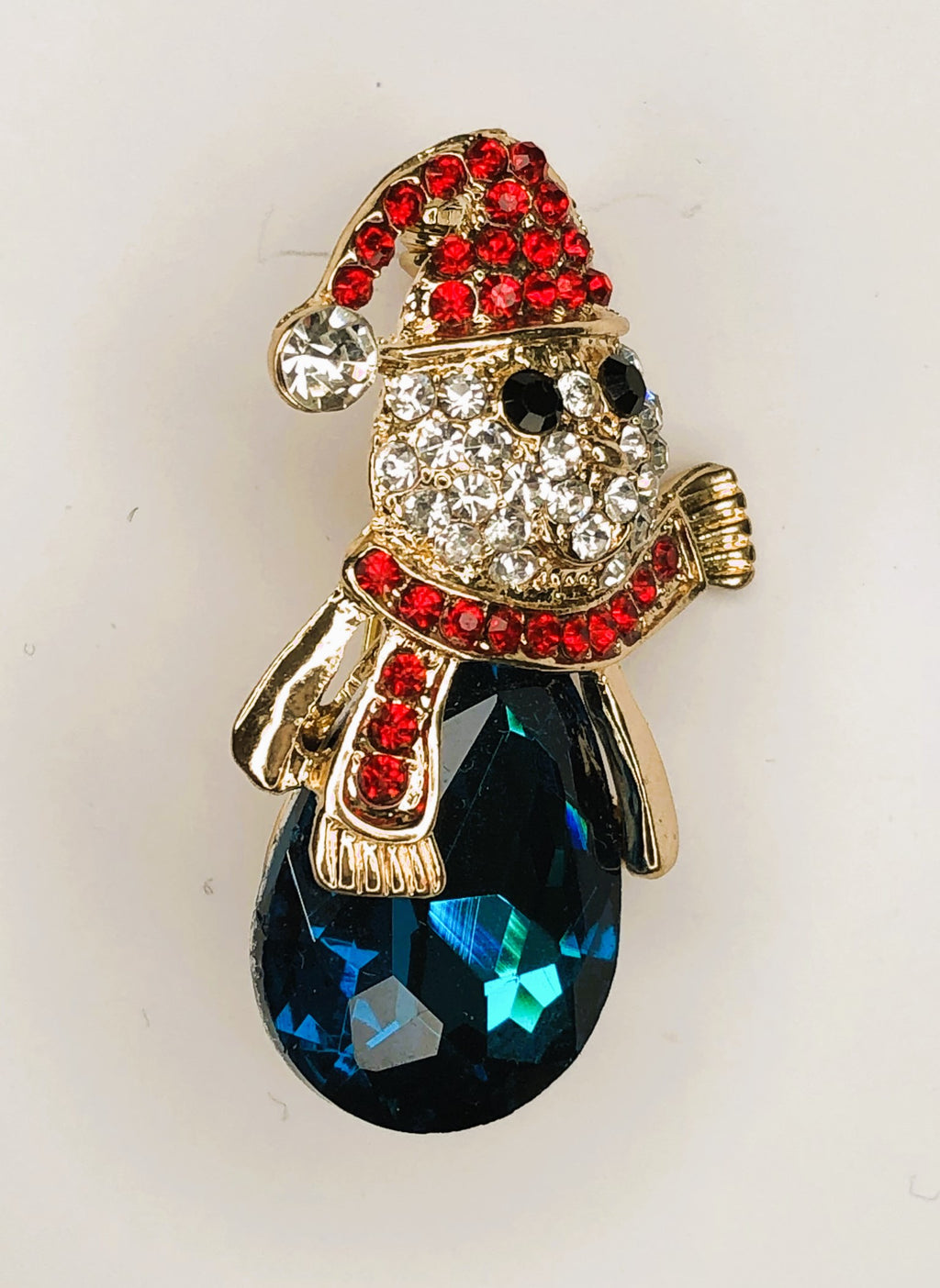 Snowman head with scarf and cap on blue stone brooch at erika