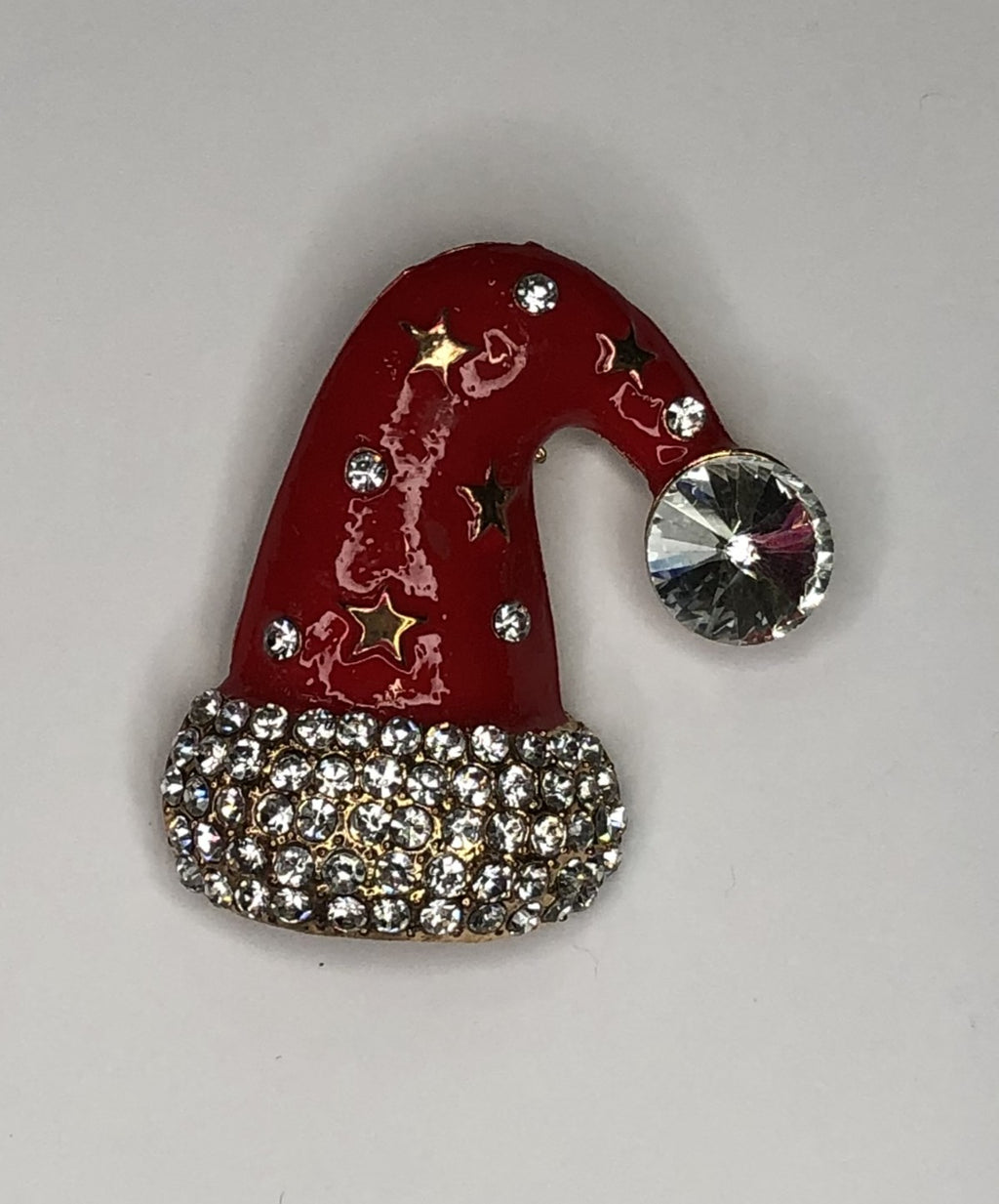 Red Santa hat with gold stars and large diamante pompom brooch at erika