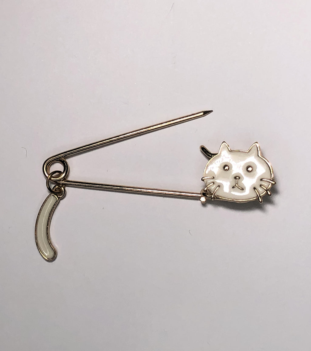 White enameled kilt pin with cat at erika