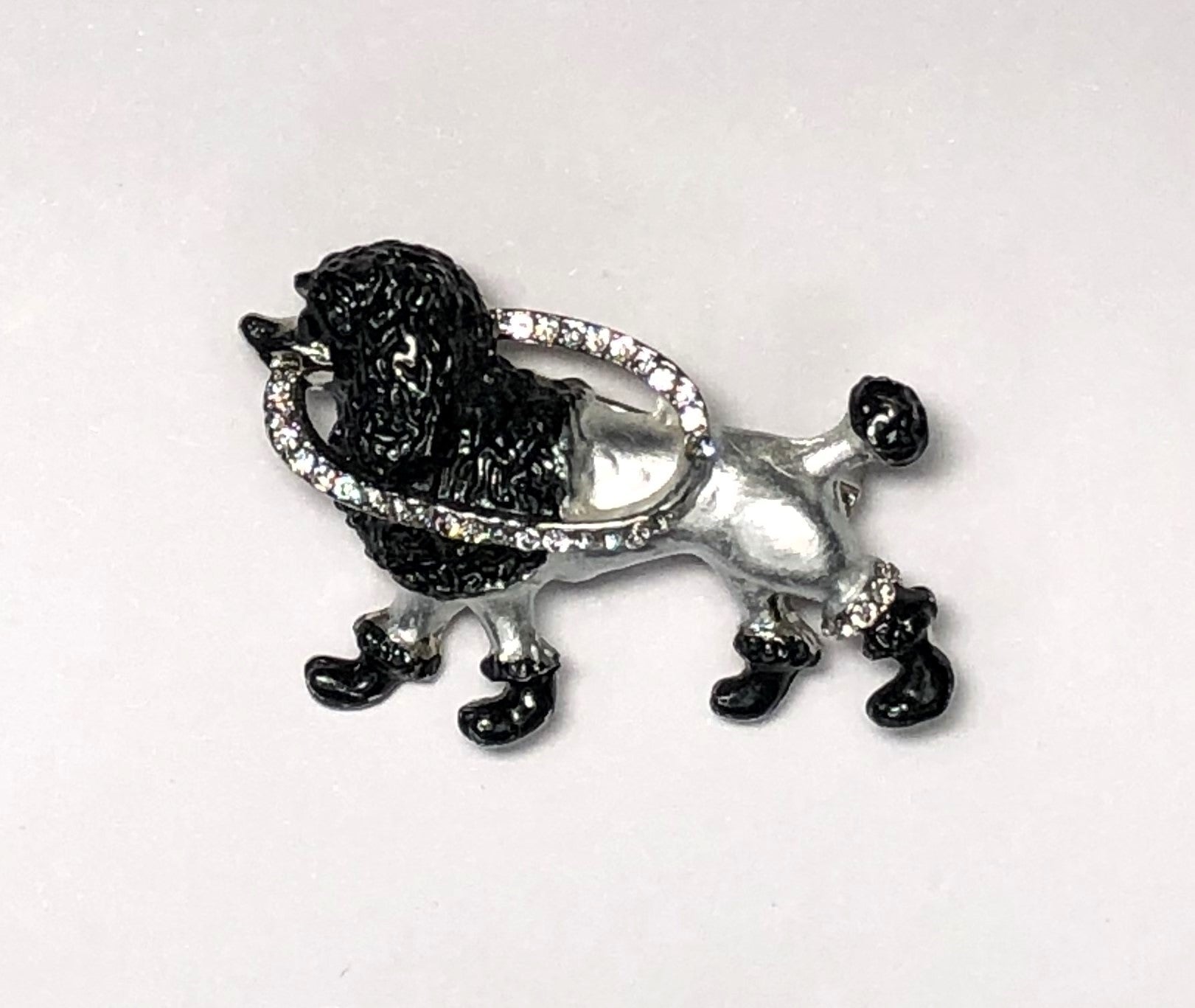 Black and silver poodle dog brooch with continental clip at erika