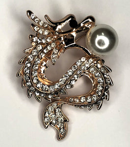 Gold and diamante dragon holding pearl brooch at erika