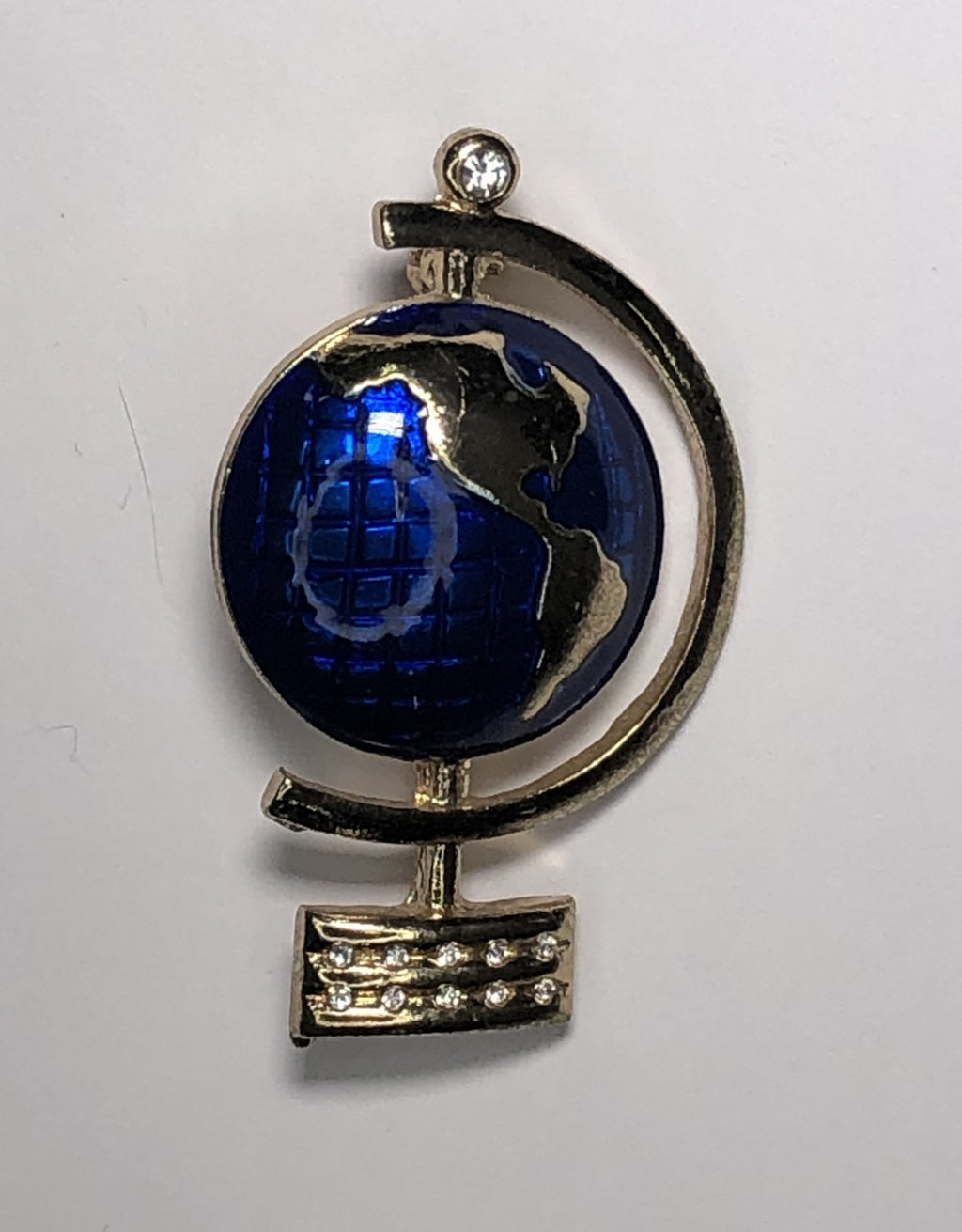 World globe in blue and gold brooch at erika