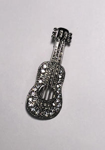 Silver guitar encrusted with clear diamantes brooch at erika