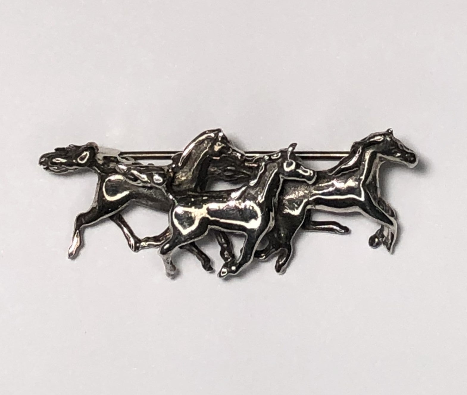 Three horses galloping sterling silver brooch at erika