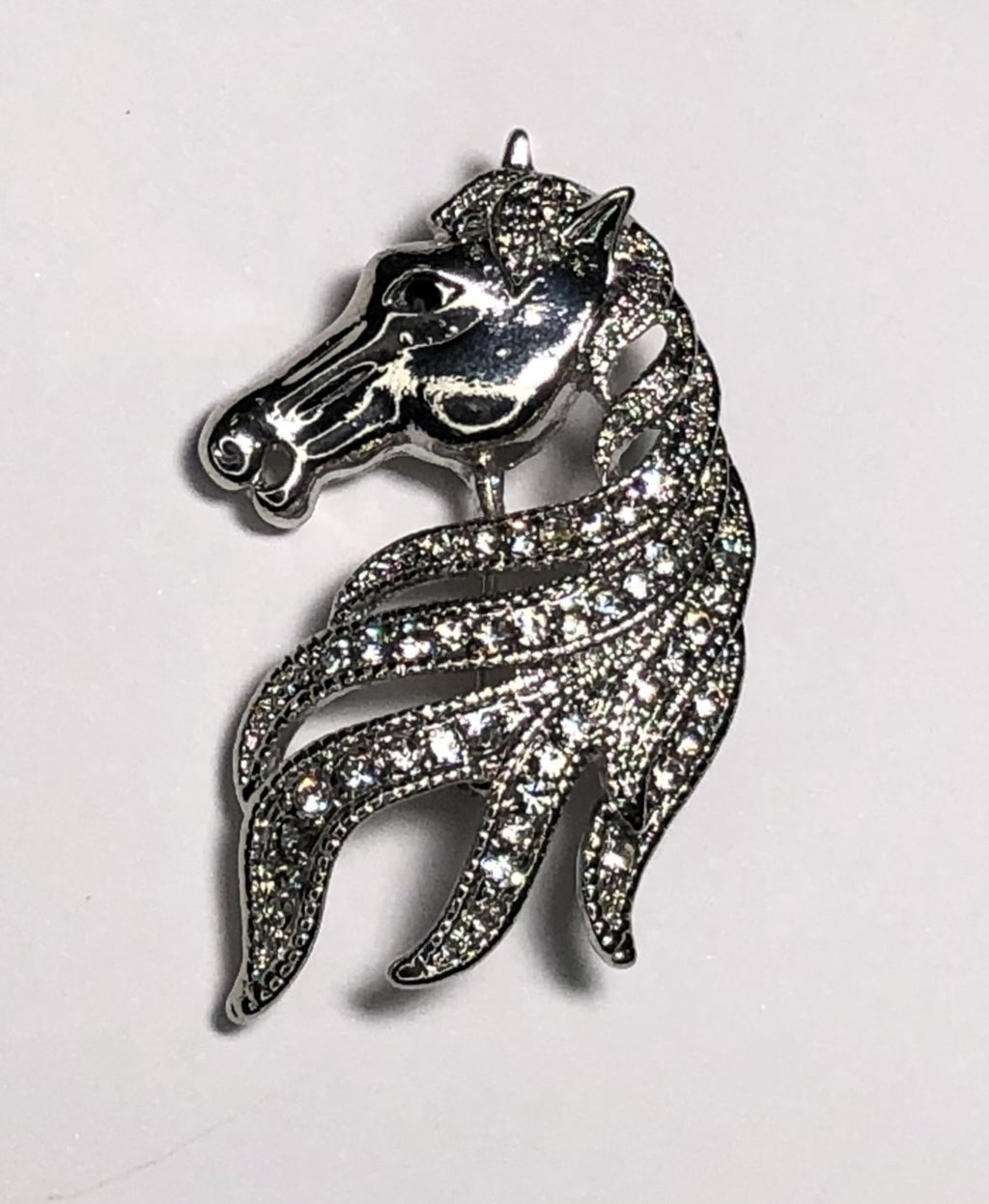 Silver horse showing mane with diamante brooch at erika