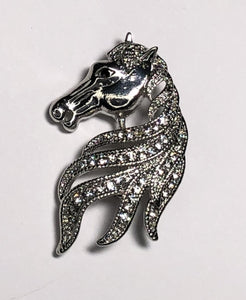 Silver horse showing mane with diamante brooch at erika