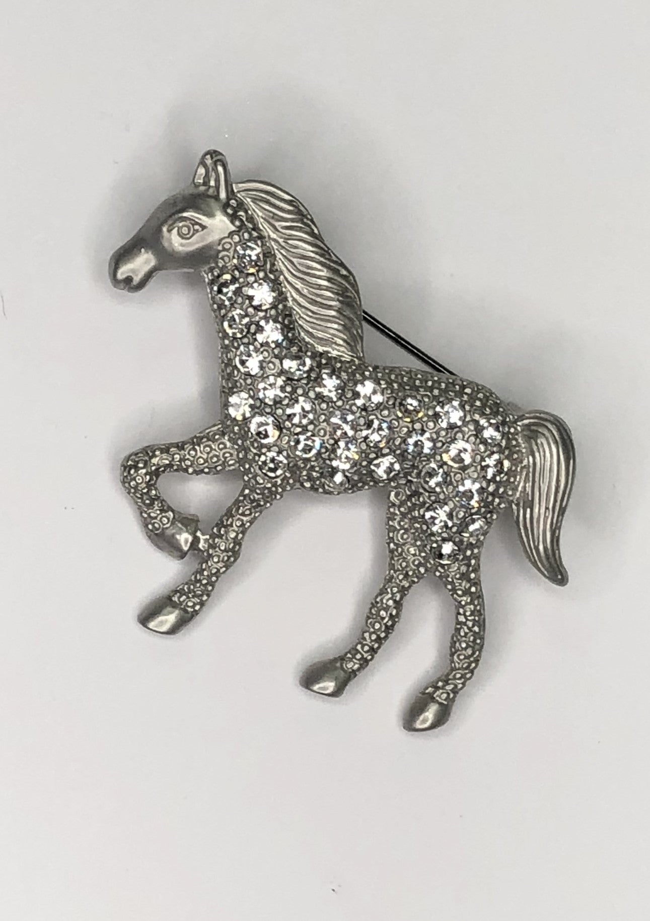 Prancing silver horse with diamante body brooch at erika