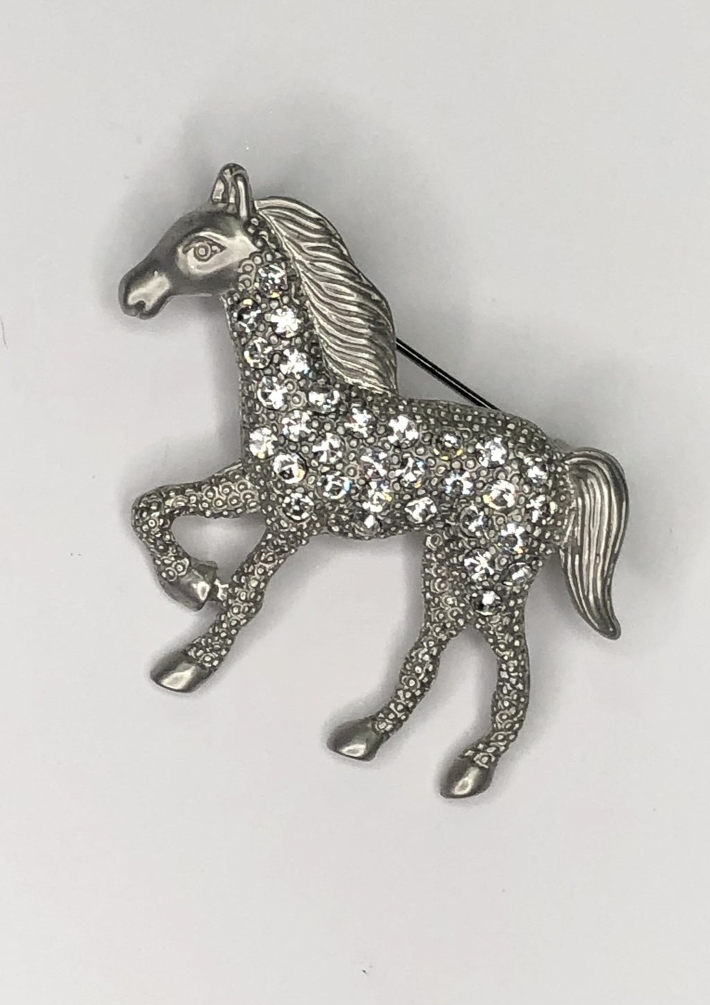Prancing silver horse with diamante body brooch at erika