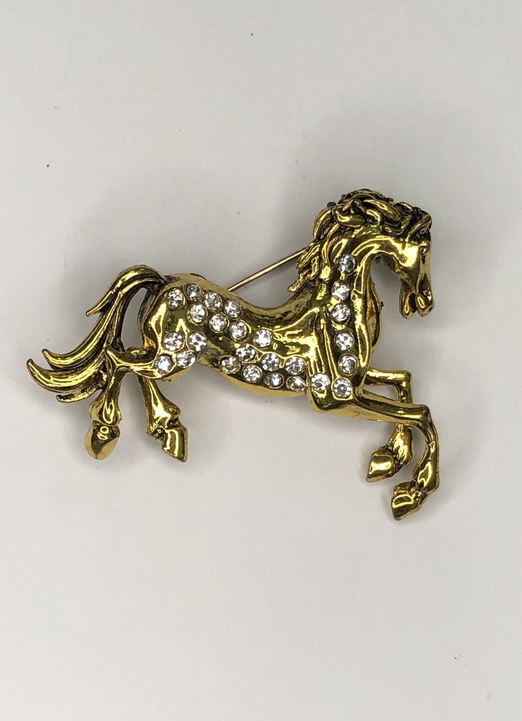 Gold prancing horse with diamante body brooch at erika