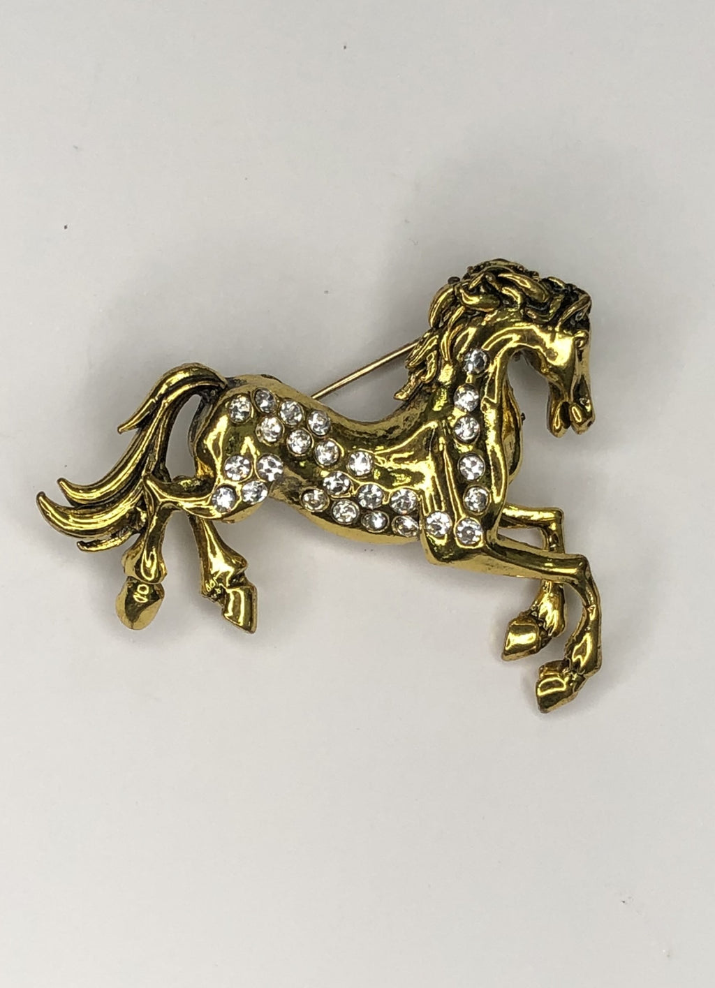 Gold prancing horse with diamante body brooch at erika