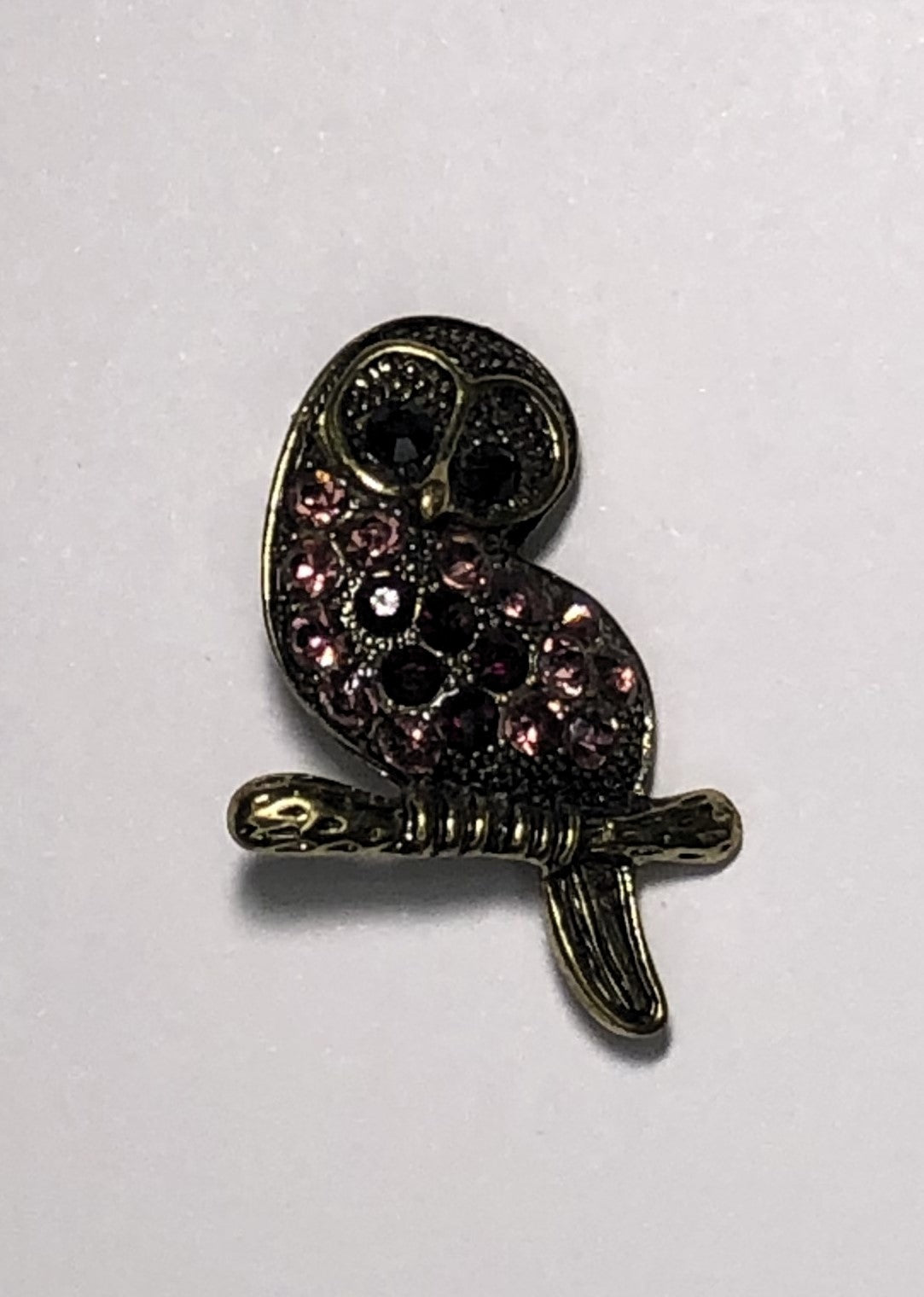 Gold amethyst bejewelled owl sitting on branch brooch at erika