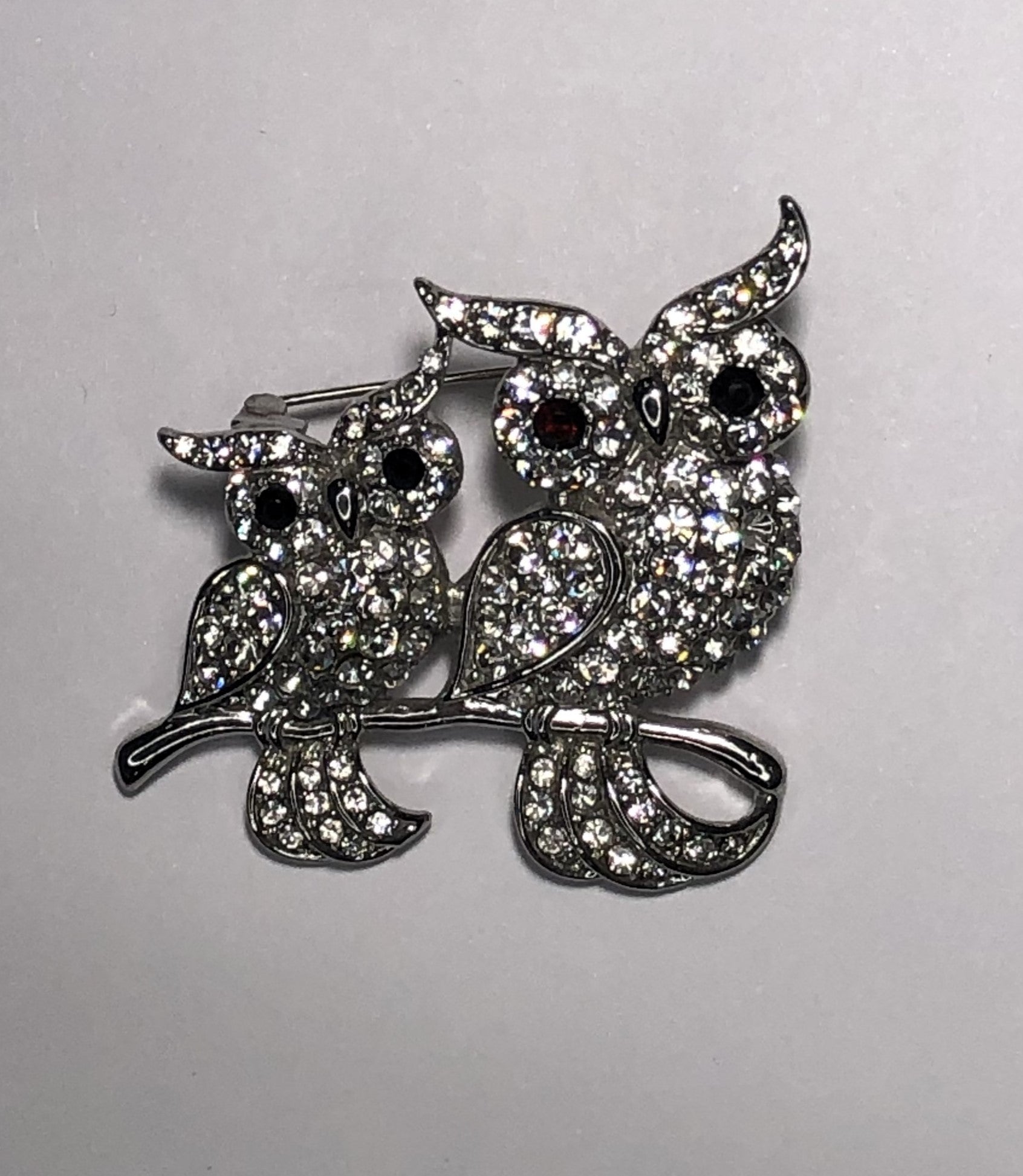 Pair of silver and diamante owls brooch at erika