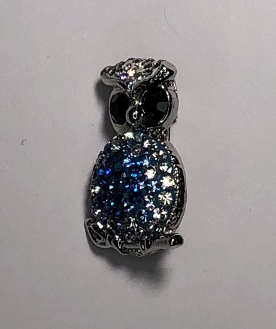 Small silver owl with blue diamante body brooch at erika