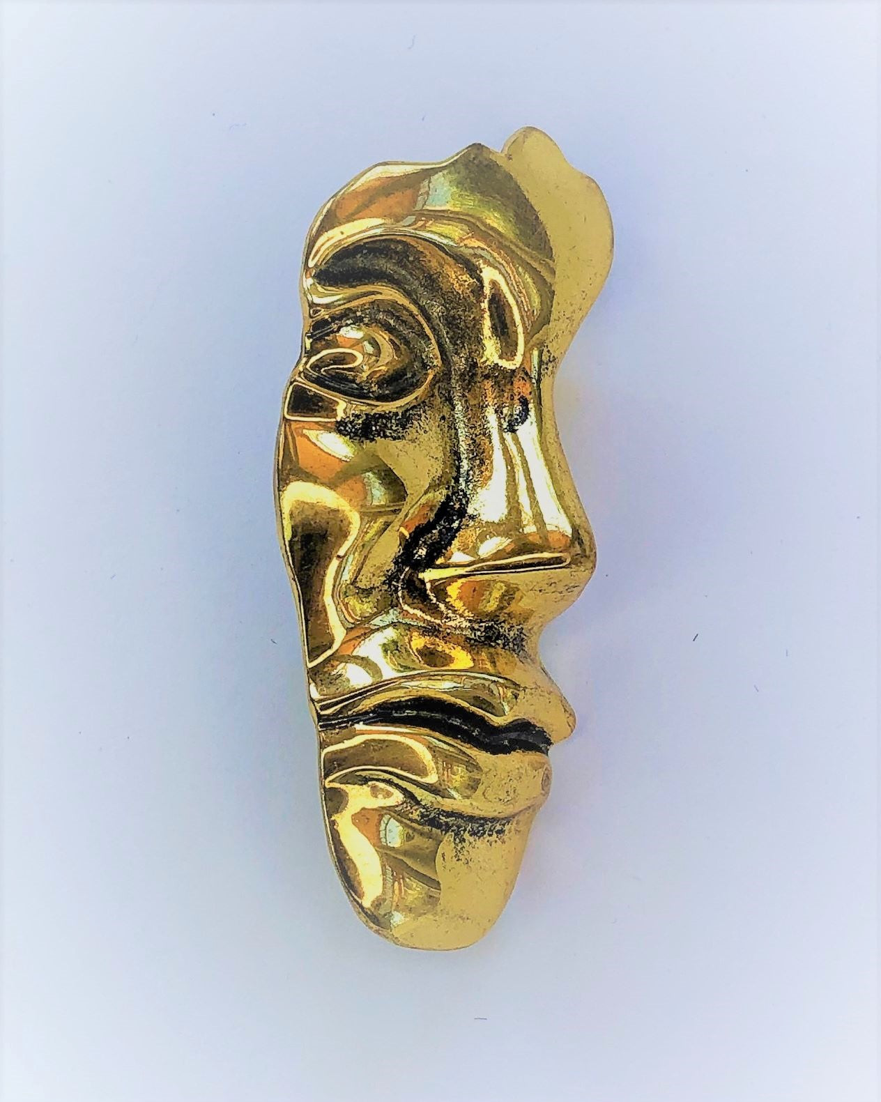 Gold face profile brooch at erika